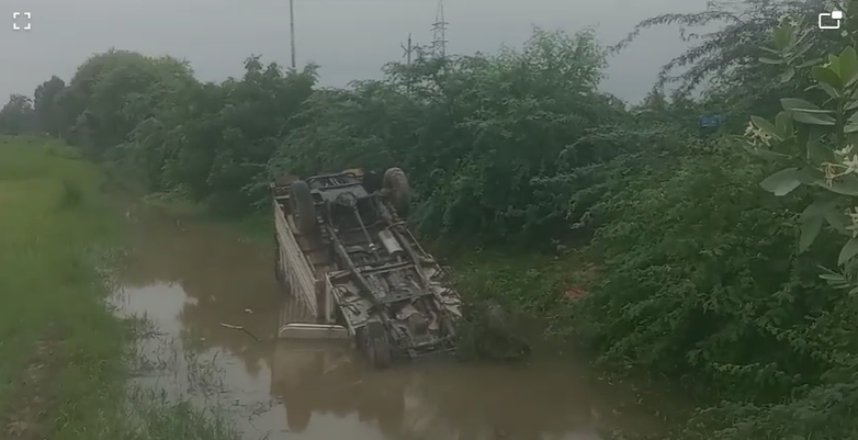Pickup overturned in water after hitting